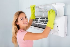 Woman-Checking-Air-Conditioner-838830820_8660x5773